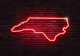 Neon sign on a brick wall in the shape of North Carolina.(illustration series)
