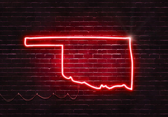 Neon sign on a brick wall in the shape of Oklahoma.(illustration series)