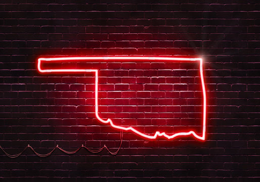Neon sign on a brick wall in the shape of Oklahoma.(illustration series)