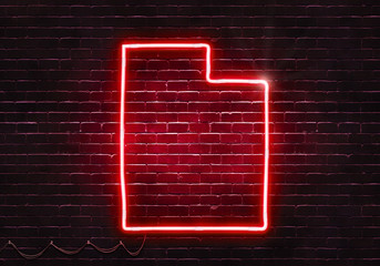Neon sign on a brick wall in the shape of Utah.(illustration series)