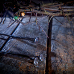 Bloody nails and crown of thorns as symbol of suffering and crucifixion of Jesus Christ