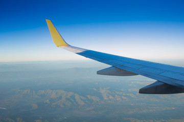 Fototapeta na wymiar Wing aircraft in altitude during flight