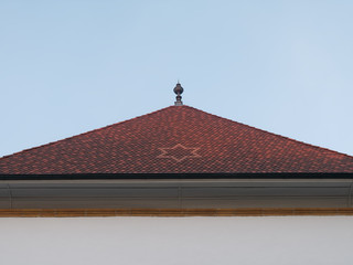 Close-up of the rooftop of the German Church in Murten or Morat in Switzerland at dusk. Beautiful roof tiles with star symbol.