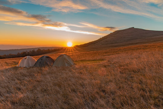 people travel life style concept wallpaper picturesque photography three tents camp side place in highland Carpathian mountain landscape environment in romantic time sunset orange lighting
