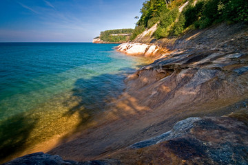 Fototapeta na wymiar Afternoon light on the shoreline of Pictured Rocks National Lakeshore in Michigan's Upper Peninsula.