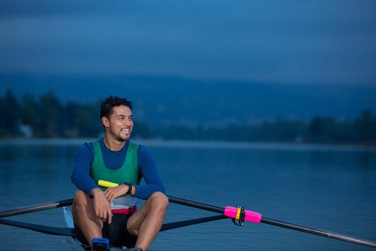 rowing man on lake smiling