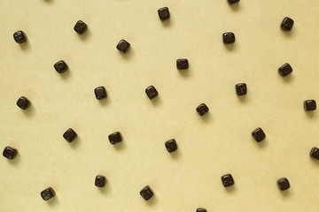 Cacao chocolate balls pattern on brown background. Flat lay, top view