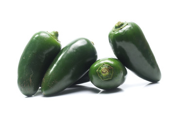 green chilies on white background (jalapeno)