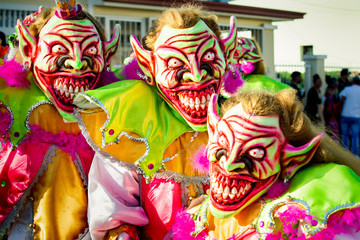 closeup men in pied scary clowns costumes pose for photo at dominican carnival