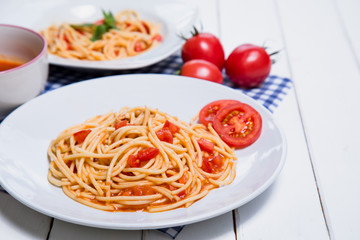 Spaghetti pasta with and tomato sauce on wood background