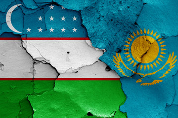 flags of Uzbekistan and Kazakhstan painted on cracked wall