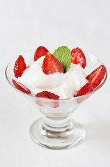 cheese cream. whipped curd cream with strawberries. Homemade cottage cheese is whipped with cream. Chamomile flowers. A useful dessert. On a light background.