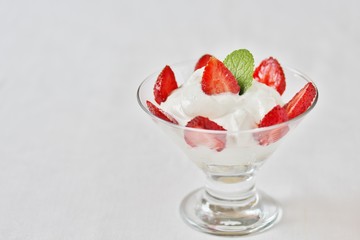 cheese cream. whipped curd cream with strawberries. Homemade cottage cheese is whipped with cream. Chamomile flowers. A useful dessert. On a light background.