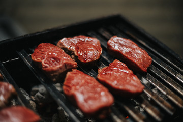 raw meat on a barbecue grill