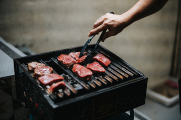 raw meat on a barbecue grill