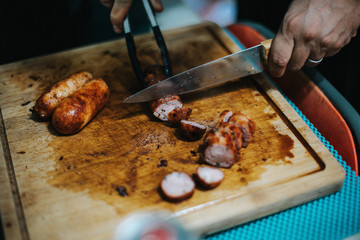 knife cutting sausages on a cutting board