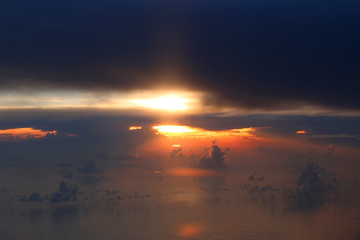 Dramatic cloudscape during sunset from the airplane's window
