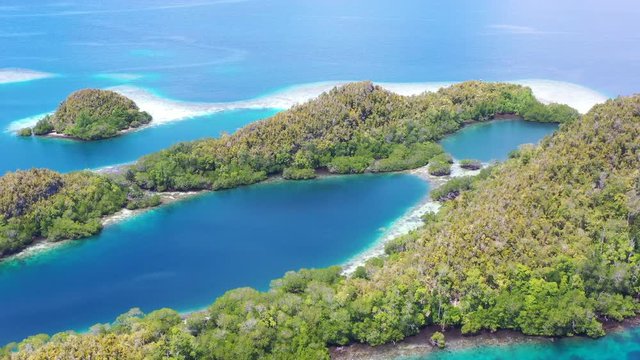 A maze of limestone islands rise from Raja Ampat's beautiful seascape. This area in Indonesia is known to be the heart of marine biodiversity and is a popular destination for divers and snorkelers.