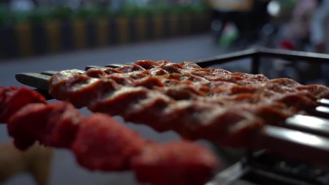 Kebabs cooked with skewers on the street of Mumbai India in the evening