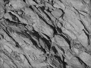 Grunge gray background. Monochrome mountain texture. Close-up. Gray rock background. Grunge stone background.