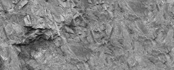 Gray white abstract background. Monochrome texture of the mountain. Close-up. Gray stone...