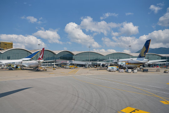 HONG KONG, CHINA - CIRCA APRIL, 2019: Cathay Dragon and Singapore Airlines aircrafts on tarmac in Hong Kong International Airport.