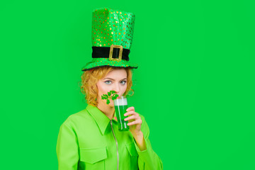 Green beverage with clover. Irish Traditions. St Patricks Day. Woman drink beer. Spring festival....