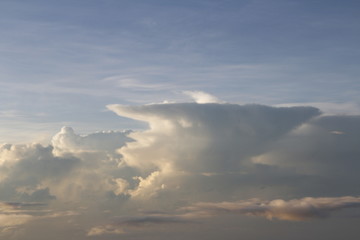 Fototapeta na wymiar Dramatic cloudscape during sunrise from the airplane's window