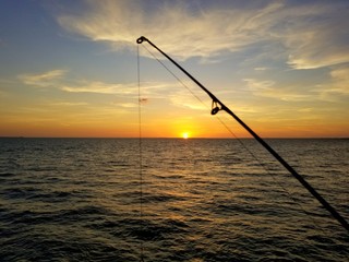 Beautiful sunset through a fishing rod near Skyway Fishing Pier, St Petersburg, Florida, U.S.A