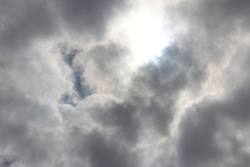 Dramatic and fluffy cloudscape with the sun at Amsterdam