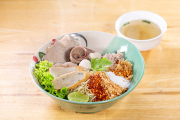 Noodle soup with pork on wood table