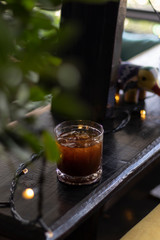 transparent glass of iced black coffee or americano on wooden table