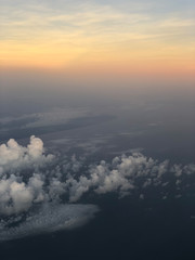 Dramatic cloudscape during sunrise from the airplane's window