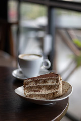 closeup tiramisu at coffee shop in a wooden table