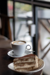 closeup capuccino at coffee shop in a wooden table