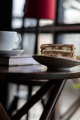 closeup tiramisu cake at coffee shop in a wooden table