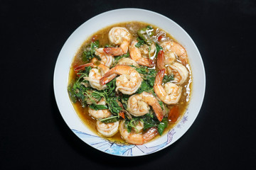 Fototapeta na wymiar Stir fried shrimp with basil on a white plate. Thai food.