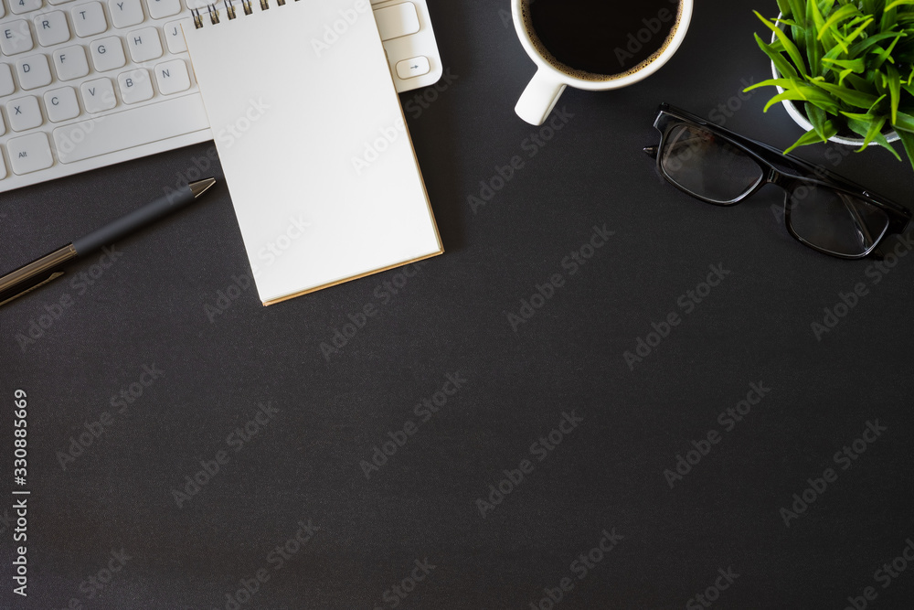 Aufkleber workplace office with dark black desk. top view from above of keyboard with notepad and coffee cup. 