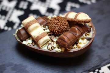 Delicious chocolate Easter eggs on gray background