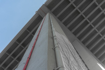 Underneath View of bridge pillars, pipes and concrete bridge of highways with the background of the sky in the day time