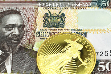 A macro image of a Kenyan fifty shilling note with a gold coin.  Shot close up.