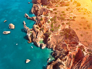 View of stunning turquoise beach of golden color rocks, Algarve, Portugal.