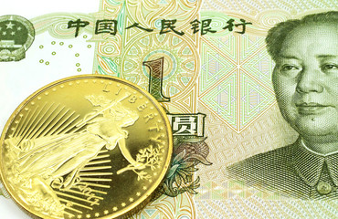 A macro image of a green Chinese one yuan bill with a gold coin.  Shot close up.
