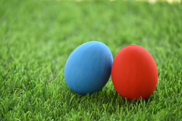 Fototapeta na wymiar red and blue easter egg on lawn green grass artificial, concept image of morning in springtime