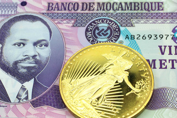 A macro image of a purple metical bank note from Mozambique with a gold coin.  Shot close up.