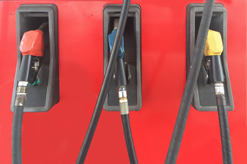 Old fashioned image of oil hose or petrol pump filling nozzles panel at gas station.