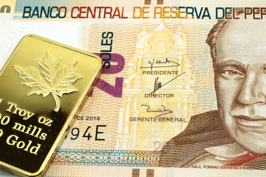 A macro image of a twenty Peruvian soles banknote with a gold bar.  Shot close up.