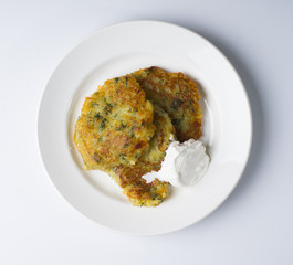 Potato pancakes Draniki on a white plate. Russian, Belorussian and Ukrainian cuisine. View from above