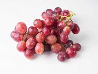 A bunch of pink large grapes on a white background. Studio photography
