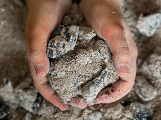 burnt ashes in a child 's hand